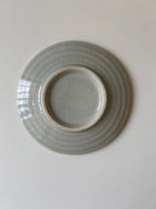 Ceramic plate with textured design on a plain background