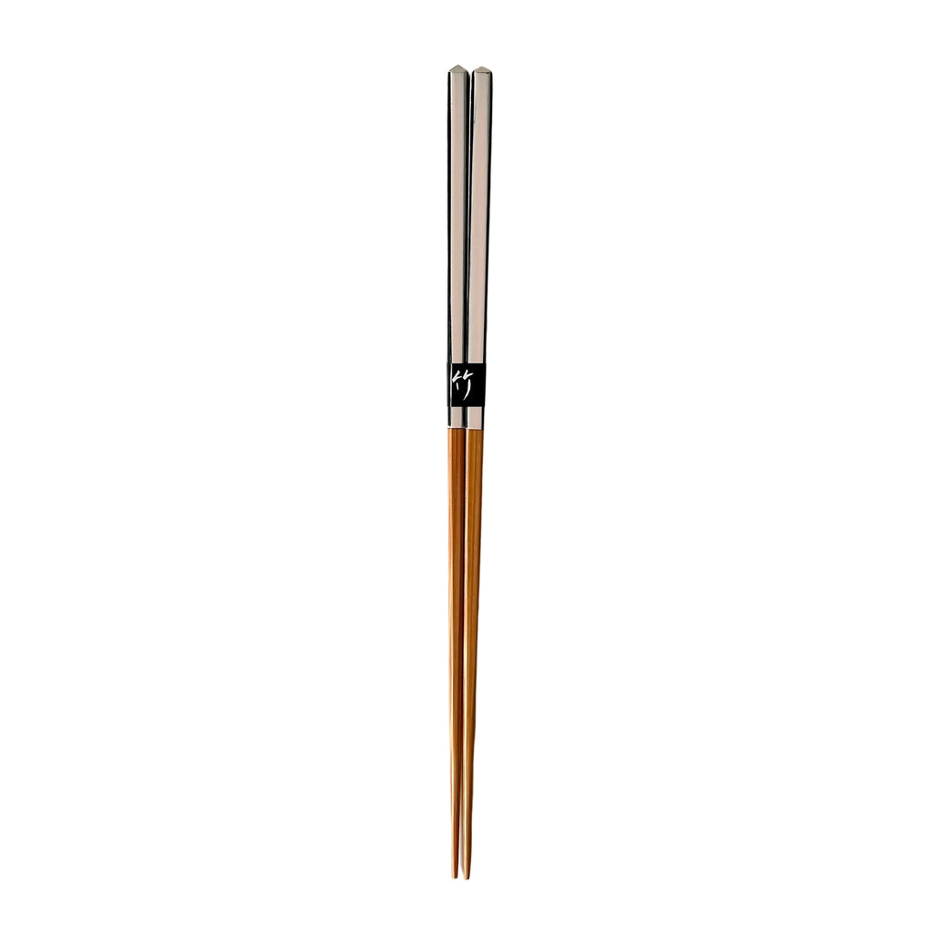 Pair of wooden chopsticks with silver accents on a white background