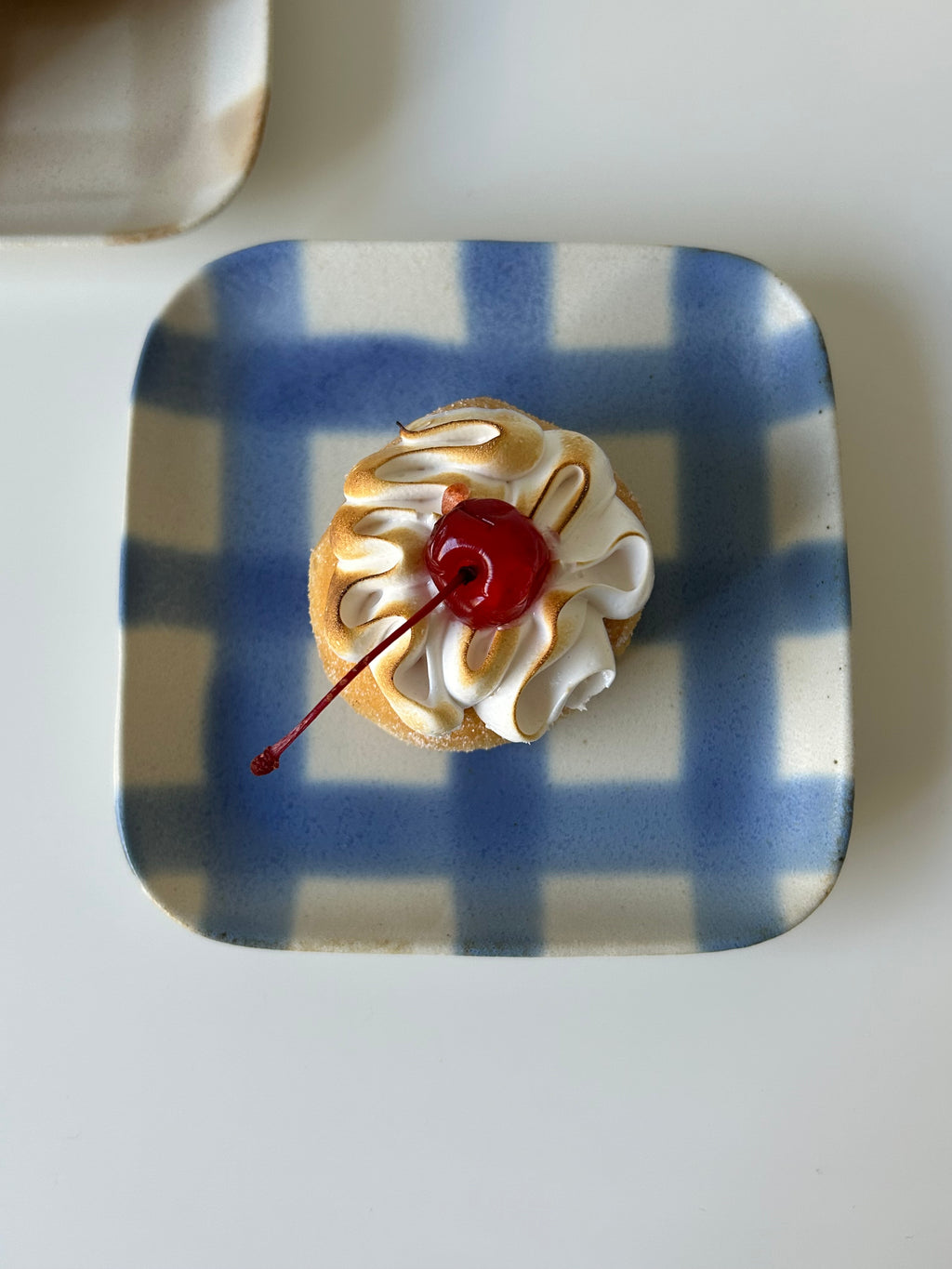 handmade blue checkered plate with a cake