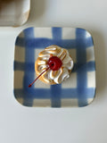handmade blue checkered plate with a cake