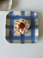 handmade blue checkered plate with a cake