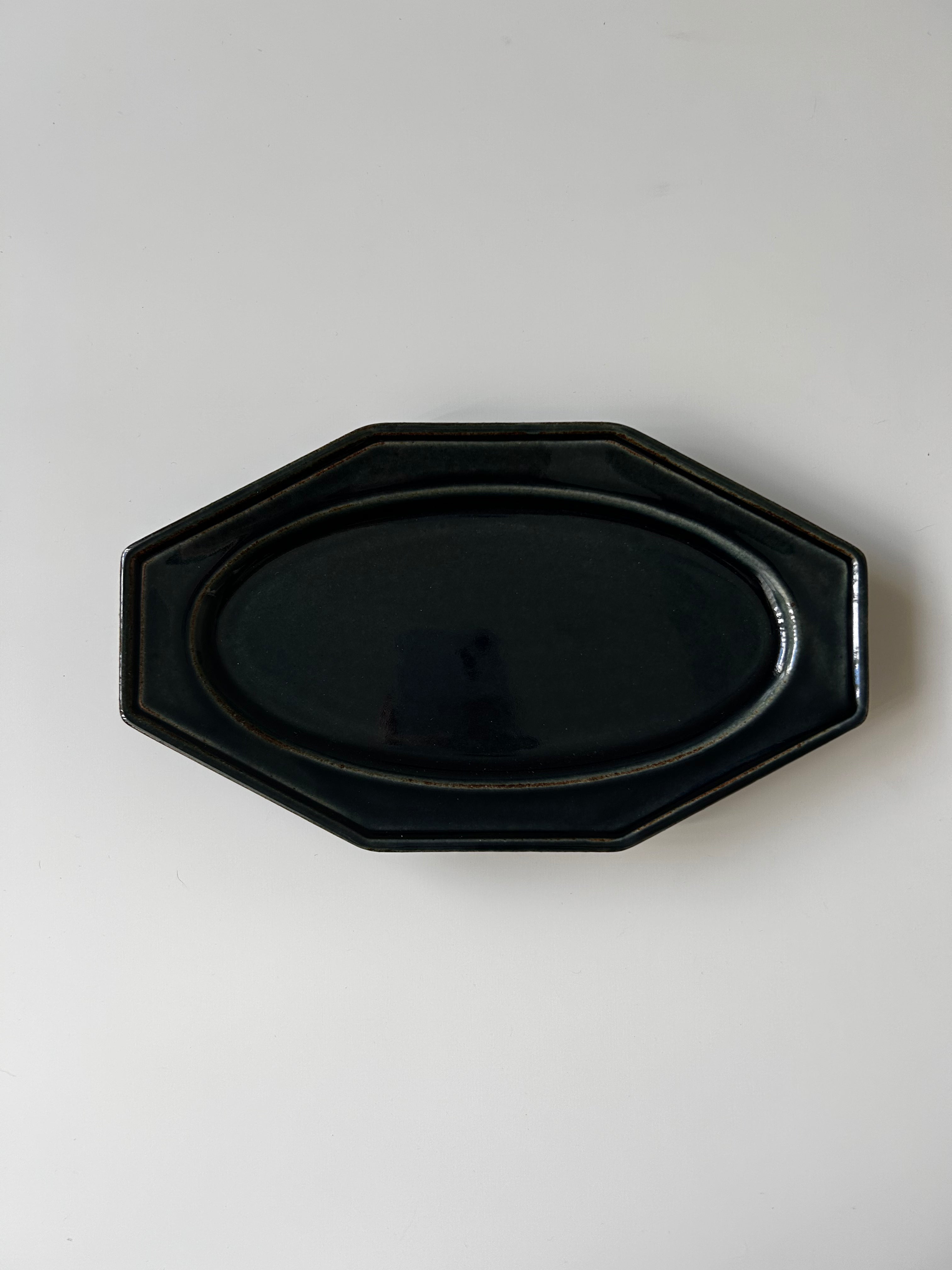 Black octagonal plate on a white background