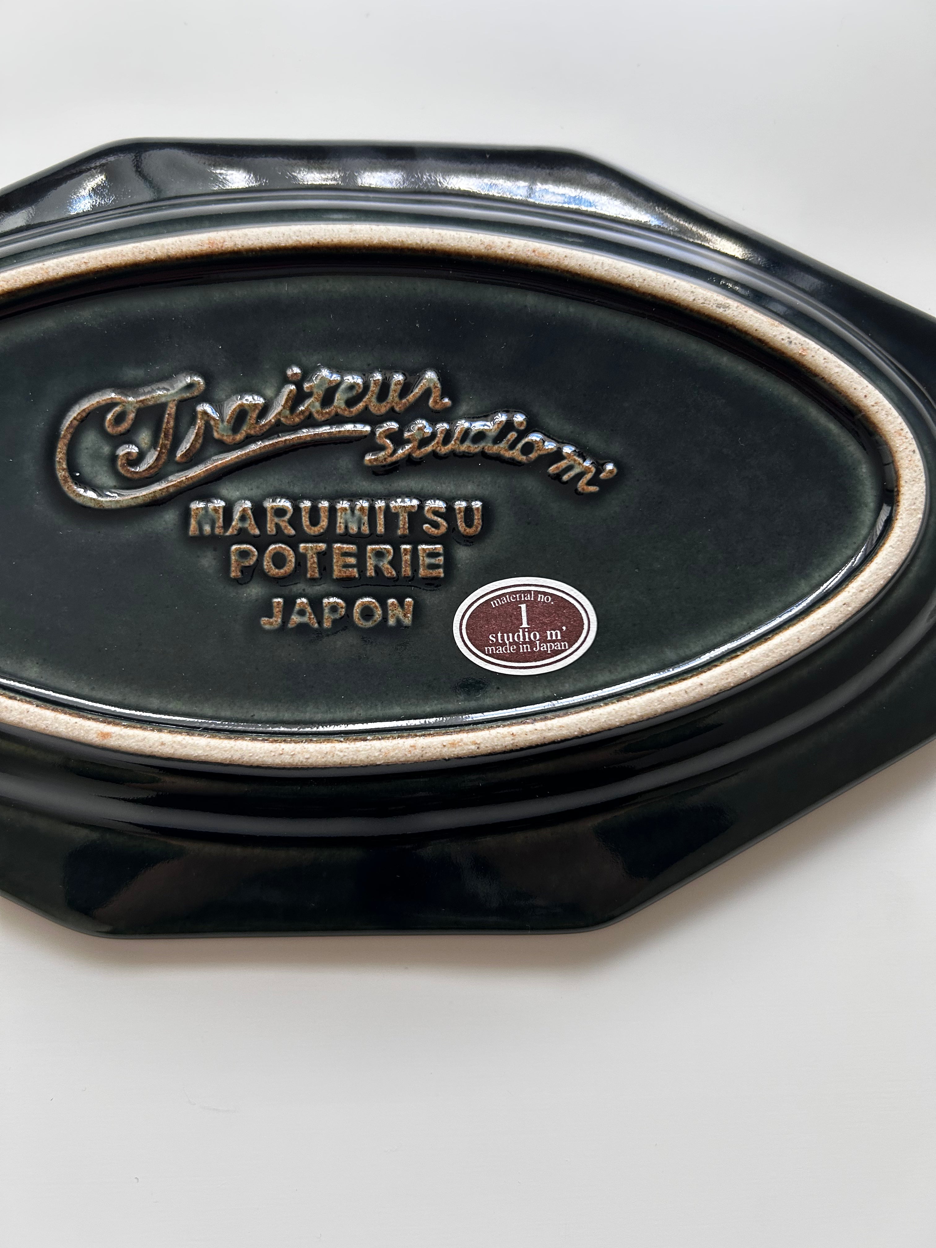 Black ceramic dish with 'Marumitsu Poterie Japon' branding on a white background